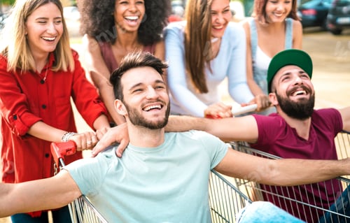 Preview: Young happy people having fun together on shopping carts