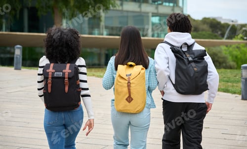 Preview: Three young students walking down a sidewalk to the University, each carrying a backpack