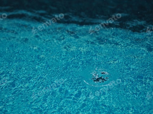 Preview: Rain drops falling blue water in pool background ripples surface texture, glittering bokeh abstract