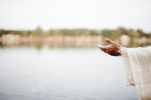 Preview: Closeup shot of Jesus Christ lending a hand for help with a blurred background