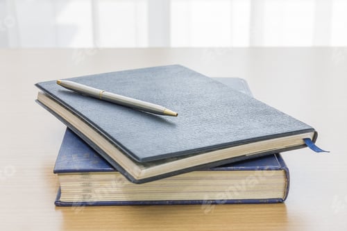 Preview: Black book with glasses and pen
