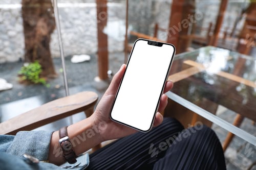Preview: Mockup image of hands holding black mobile phone with blank desktop screen
