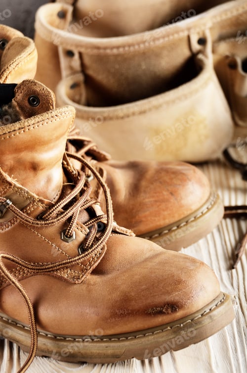 Preview: Yellow leather used work boots and tool belt on wooden backgroun