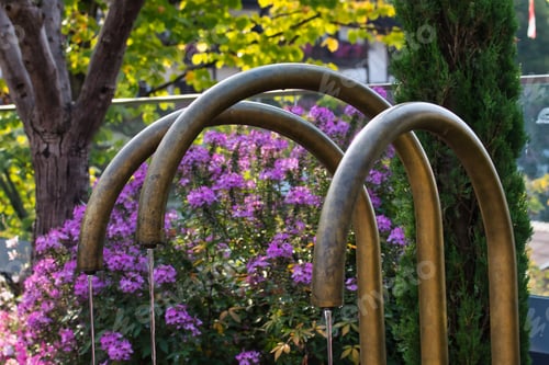 Preview: Close-up of a set of park faucets set against a green background