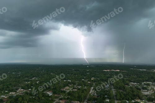 Preview: Dark stormy clouds forming on gloomy sky before heavy rainfall over suburban town area