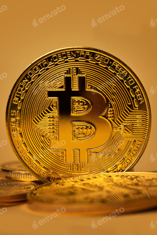 Preview: Closeup of shiny gold bitcoin on yellow backgound