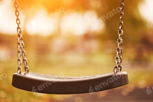 Preview: Empty children swing at sunset