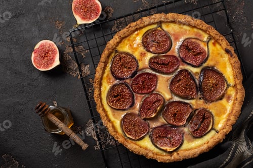 Preview: Homemade quiche tart with figs, cream cheese and honey on dark brown background. Vintage style. Top