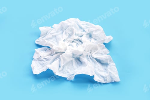 Preview: Crumpled tissue paper. Facial tissue on blue background.