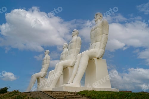Preview: White Men statues, Esbjerg, Denmark. Four white men sitting looking at the sea near Esbjerg