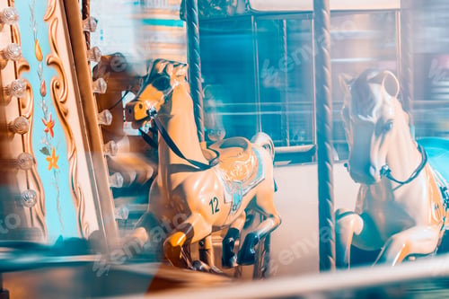 Preview: Vintage carousel with horses in the amusement park.