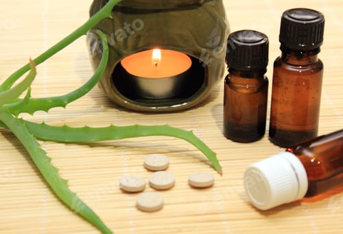 Preview: Essential oils, sprig of aloe, nutritional supplements and an aroma lamp are on table