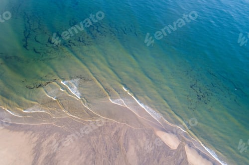 Preview: Drone aerial view of a beach shore at sunrise