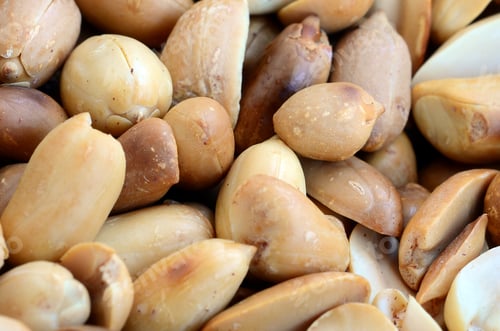Preview: Peanut. A lot of small yellow nuts without peel. Background texture