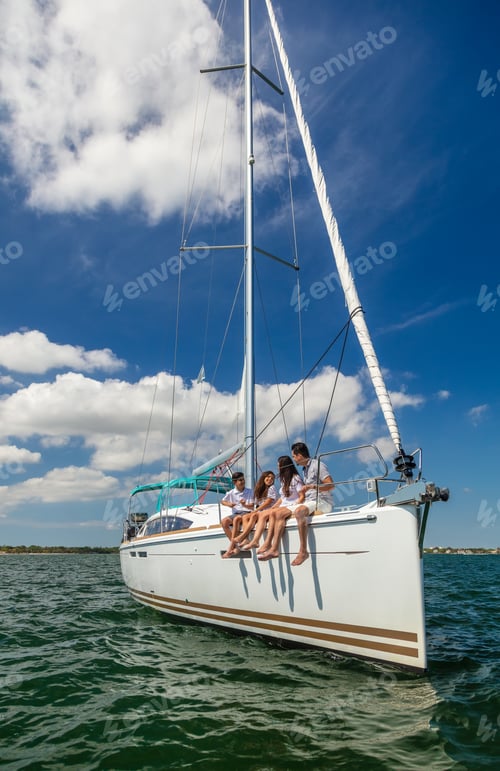Preview: Latino family enjoying healthy outdoor vacation on yacht