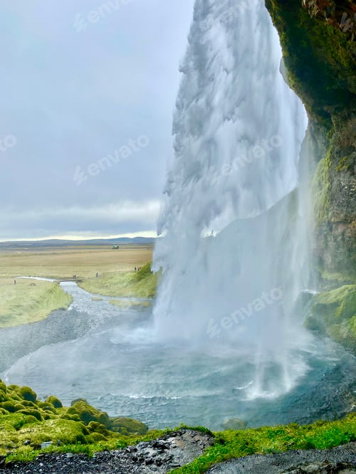 Preview: A view of an Icelandic waterfall from the cave behind it.