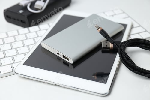 Preview: Powerbank, cord and tablet on white background, close up