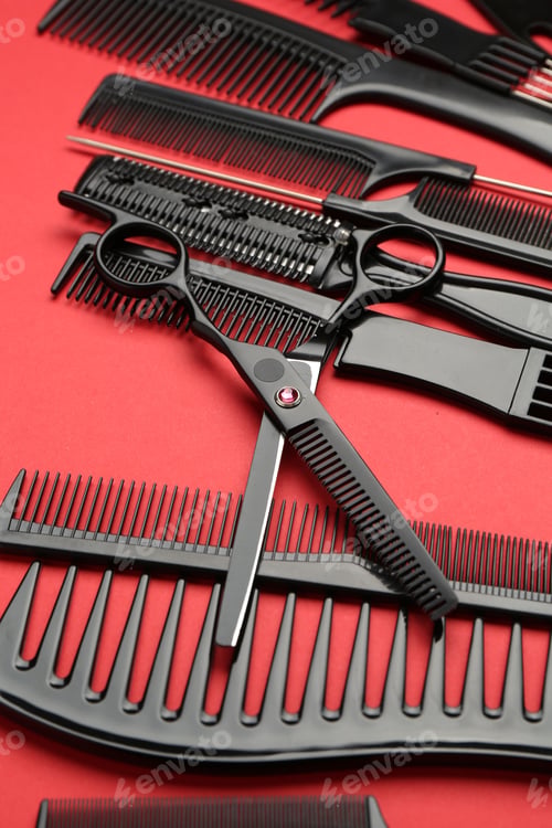 Preview: Different hairdresser's tools on red background, closeup