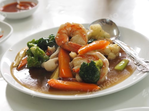 Preview: big flat Fried noodle with seafood shrimp and kale soaked in gravy on white plate