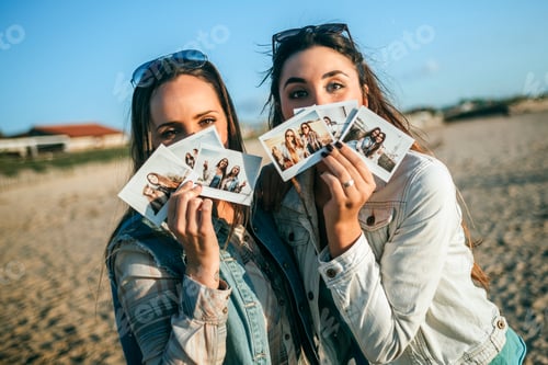 Preview: Friends holding instant photos in front of their face