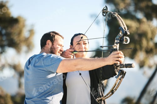 Preview: Archery, shooting range and sports training to aim with a woman and man outdoor for target practice