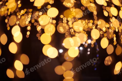 Preview: Yellow lights bokeh from christmas holiday garlands, blurred festive background, abstract lights