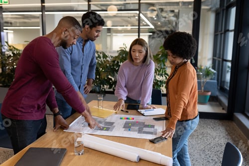 Preview: Diverse group of business people working in creative office