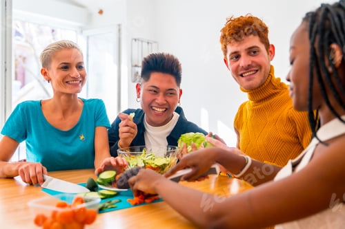 Preview: Portrait of a group of friends preparing vegetarian food. Preparing the salad and having fun