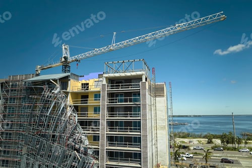 Preview: Aerial view of ruined by hurricane Ian construction scaffolding on high apartment building