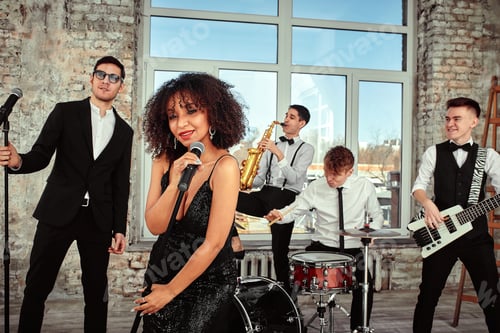 Preview: A multiracial music group performs in a recording studio. A group of international musicians