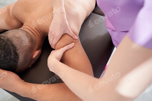 Preview: Male patient receiving therapeutic massage in wellness center