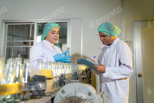 Preview: Team of worker quality control a fruit drink factory in glass