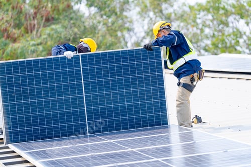 Preview: workers installing solar panels, for efficient energy on rooftop