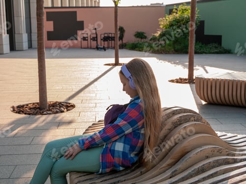 Preview: Blonde child headphones listening to music podcast Young girl online lesson audio book Mental health