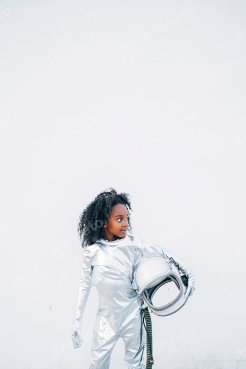 Preview: Little girl wearing space suit in front of white background looking around
