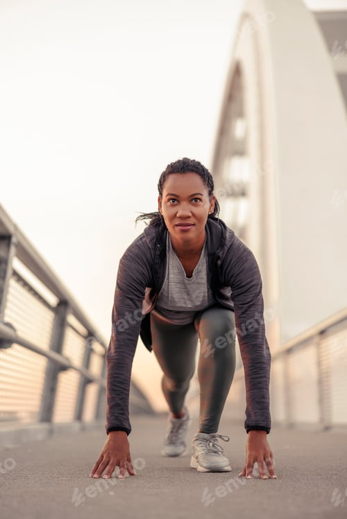 Preview: Woman in low start pose going for morning jogging
