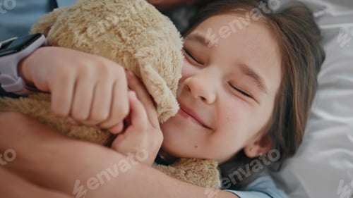 Preview: Morning kid embracing toy bonding unknown mother at bed closeup. Child playing