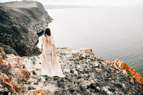Preview: Beautiful woman in white dress at epic landscape
