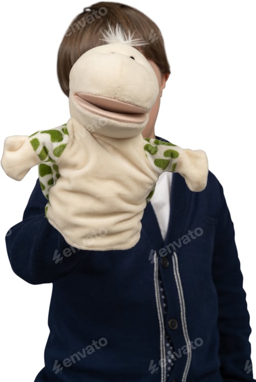 a young boy wearing a stuffed animal puppet on his face