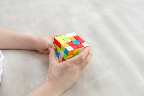 Preview: Boy’s hand on the couch playing rubik's cube logic game, iq game