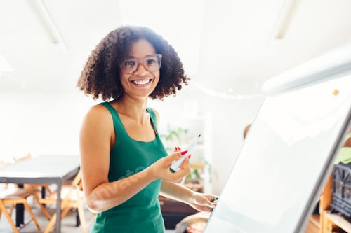 Preview: Beautiful African American girl with dark curly hair standing near board and giving presentation