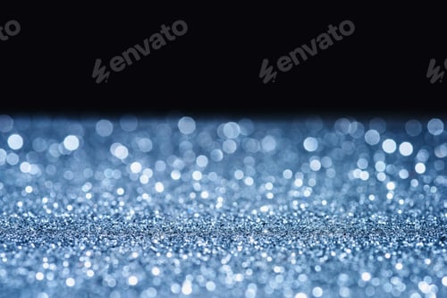 Preview: selective focus of blurred sparkling surface on black