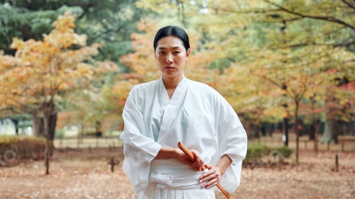 Preview: Training, serious and woman with skills martial arts and weapon for practice, fighter and aikido. O