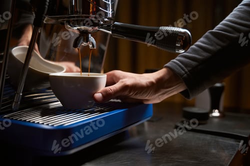 Preview: Hands of barista making coffee with espresso machine