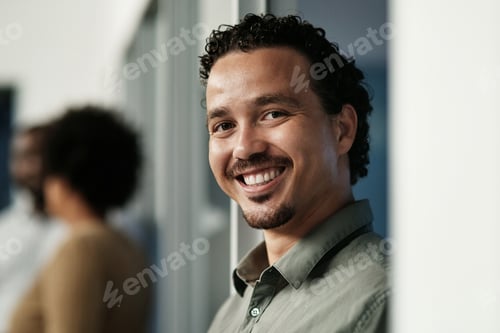 Preview: Shot of a handsome young businessman standing in the office during the day