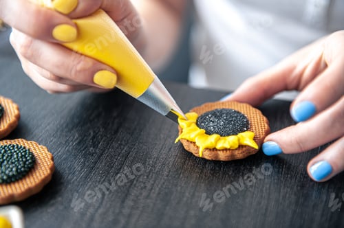 Preview: Woman confectioner making gingerbread, sunflower gingerbread design.