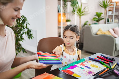 Preview: Mother and daughter engage in creative painting at home on a sunny afternoon