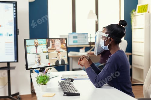Preview: African team leader talking wtih her coworkes via online call