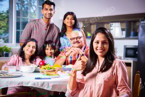 Preview: Happy Indian asian family having lunch at home and posing for photo