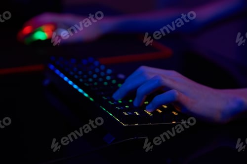 Preview: Gamer play computer game, use rgb neon colored keyboard